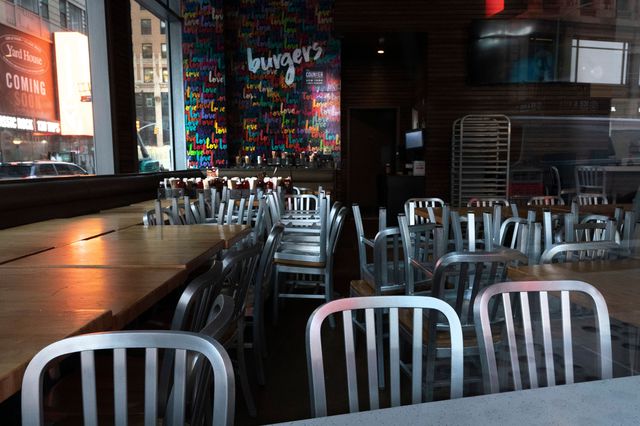 an empty interior of a restaurant, with empty tables and chairs